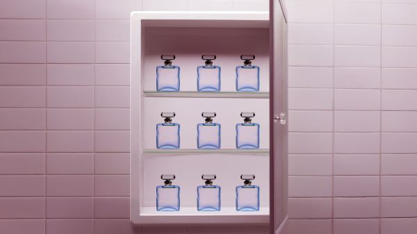 A cabinet containing nine of the same perfume bottles.